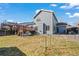 Backyard featuring a well-maintained lawn, a wooden deck, and inviting patio space for outdoor relaxation and entertaining at 908 Cinnamon Ln, Louisville, CO 80027