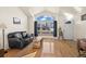 Bright living room with vaulted ceilings, a large arched window, and hardwood floors at 908 Cinnamon Ln, Louisville, CO 80027