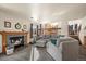 Comfortable living room with a fireplace, neutral colors, and a carpeted floor at 908 Cinnamon Ln, Louisville, CO 80027