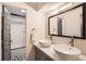 Modern bathroom featuring double vanity, vessel sinks, and stylish black and white patterned tile floor at 717 S Carr Ave, Lafayette, CO 80026