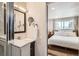 Well-lit bathroom with vanity, sink, and access to the bedroom at 717 S Carr Ave, Lafayette, CO 80026