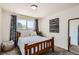 Comfortable bedroom with a wood frame bed, matching decor, and a window overlooking the outdoors at 717 S Carr Ave, Lafayette, CO 80026
