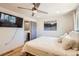 Cozy bedroom features a ceiling fan, mounted TV and an ensuite bathroom for convenience at 717 S Carr Ave, Lafayette, CO 80026