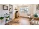 Sunlit dining area with hardwood floors, wicker chairs, and a bright window overlooking the yard at 717 S Carr Ave, Lafayette, CO 80026