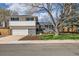 Charming two-story home with mature trees, landscaped yard, and an attached two car garage at 717 S Carr Ave, Lafayette, CO 80026