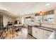Modern kitchen featuring white cabinets, stainless steel appliances, and an adjoining dining area at 717 S Carr Ave, Lafayette, CO 80026