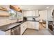 Bright kitchen featuring white cabinets, stainless steel appliances, and ample counter space for cooking at 717 S Carr Ave, Lafayette, CO 80026