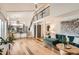 Open-concept living area featuring a fireplace, wood floors, and access to the kitchen and second story loft at 717 S Carr Ave, Lafayette, CO 80026