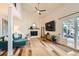 Bright living room boasts a fireplace, ceiling fan, wood floors, and sliding glass door to the patio at 717 S Carr Ave, Lafayette, CO 80026