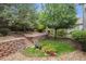 Landscaped backyard with stone steps, retaining wall, and a vibrant garden setting at 10440 Lowell Ct, Westminster, CO 80031