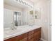 Bathroom featuring double sinks, a large mirror and contemporary lighting at 10440 Lowell Ct, Westminster, CO 80031