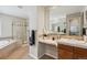 Bright bathroom featuring a shower, tub, and vanity with marble countertops and neutral tones at 10440 Lowell Ct, Westminster, CO 80031