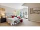 Bright bedroom with bay window, neutral walls, carpet, and comfortable seating area at 10440 Lowell Ct, Westminster, CO 80031