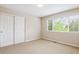 Empty bedroom featuring natural light from a window with neutral walls, carpet, and closet with doors at 10440 Lowell Ct, Westminster, CO 80031