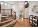 Welcoming foyer featuring wood floors, a curved staircase, and abundant natural light at 10440 Lowell Ct, Westminster, CO 80031