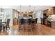 Eat-in kitchen featuring a large island with bar seating, stainless appliances and warm wood cabinets at 10440 Lowell Ct, Westminster, CO 80031