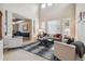 Bright living room features high ceilings, large windows, and elegant neutral décor at 10440 Lowell Ct, Westminster, CO 80031