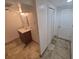 Bathroom with tiled floor, standard white vanity with mirror and lighting at 867 S Grape St, Denver, CO 80246