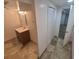 Bathroom with tiled floor, standard white vanity with mirror and lighting at 867 S Grape St, Denver, CO 80246