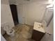 Bathroom with tiled floor, standard white toilet and vanity with mirror at 867 S Grape St, Denver, CO 80246