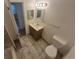 Tiled bathroom featuring a vanity with a sink, mirror, and toilet at 867 S Grape St, Denver, CO 80246