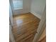 Hardwood flooring in a bedroom with standard window, walls and door at 867 S Grape St, Denver, CO 80246