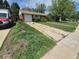 Charming single-story home featuring a front lawn and driveway leading to an attached one-car garage at 867 S Grape St, Denver, CO 80246