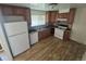 Functional kitchen featuring wood cabinets, a dual basin sink, and white appliances at 867 S Grape St, Denver, CO 80246