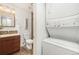 Bathroom featuring a stackable washer-dryer, dark wood vanity, and tiled floor at 5300 E Cherry Creek South Dr # 1327, Denver, CO 80246