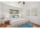 Bright bedroom featuring a window, white walls, wood floors, and stylish decor at 5300 E Cherry Creek South Dr # 1327, Denver, CO 80246