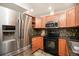 Well-equipped kitchen with stainless appliances, modern cabinetry and black countertops at 5300 E Cherry Creek South Dr # 1327, Denver, CO 80246