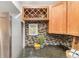 Modern kitchen featuring a wine rack, stainless steel refrigerator, and granite countertops at 5300 E Cherry Creek South Dr # 1327, Denver, CO 80246