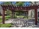 Wood pergola with shade, pathway, grassy area, and treed common space at 5300 E Cherry Creek South Dr # 1327, Denver, CO 80246