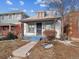 Shot of a charming bungalow-style home with a white brick facade at 805 S Lincoln St, Denver, CO 80209