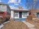 Charming bungalow-style home with a white brick facade and inviting blue porch steps at 805 S Lincoln St, Denver, CO 80209