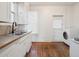 Charming kitchen features stainless steel sink, tile counters, and laundry area at 805 S Lincoln St, Denver, CO 80209