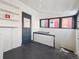 Small utility area with painted floor, shelves, windows and door at 805 S Lincoln St, Denver, CO 80209