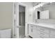 Bright bathroom featuring sleek vanity, contemporary mirror, and a glimpse into the neutral bedroom at 1285 W 9Th Ave, Denver, CO 80204