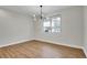 Modern bedroom features hardwood floors, bright natural light, and modern chandelier at 1285 W 9Th Ave, Denver, CO 80204