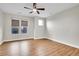 A bright, empty bedroom with a ceiling fan, wood flooring, and two large windows at 1285 W 9Th Ave, Denver, CO 80204