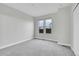 A bright, carpeted bedroom with two windows and a closet at 1285 W 9Th Ave, Denver, CO 80204