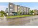 Attractive gray townhome exteriors with well-maintained landscaping along the street at 1285 W 9Th Ave, Denver, CO 80204