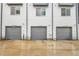 Three modern townhome garages with gray doors and clear unit number labeling at 1285 W 9Th Ave, Denver, CO 80204