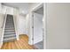 Hallway boasts hardwood floors, carpeted stairs, and access to a well-lit bathroom at 1285 W 9Th Ave, Denver, CO 80204