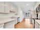 Bright kitchen featuring white cabinets, stainless steel appliances, and an open floor plan at 1285 W 9Th Ave, Denver, CO 80204