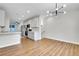 Bright, modern living room featuring a modern chandelier, hardwood floors, and a kitchen view at 1285 W 9Th Ave, Denver, CO 80204