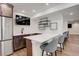 Modern basement bar featuring quartz countertops, stainless steel refrigerator, and stylish seating at 5334 Sedona Dr, Parker, CO 80134