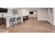 Spacious basement living area with bar, modern shelving, and wood-look flooring at 5334 Sedona Dr, Parker, CO 80134
