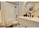 Bright bathroom featuring a shower-tub combo, white vanity with a round mirror, and tile flooring at 5334 Sedona Dr, Parker, CO 80134