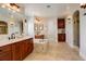 This primary bathroom features wood cabinets, double sinks, a soaking tub and a tile shower at 5334 Sedona Dr, Parker, CO 80134
